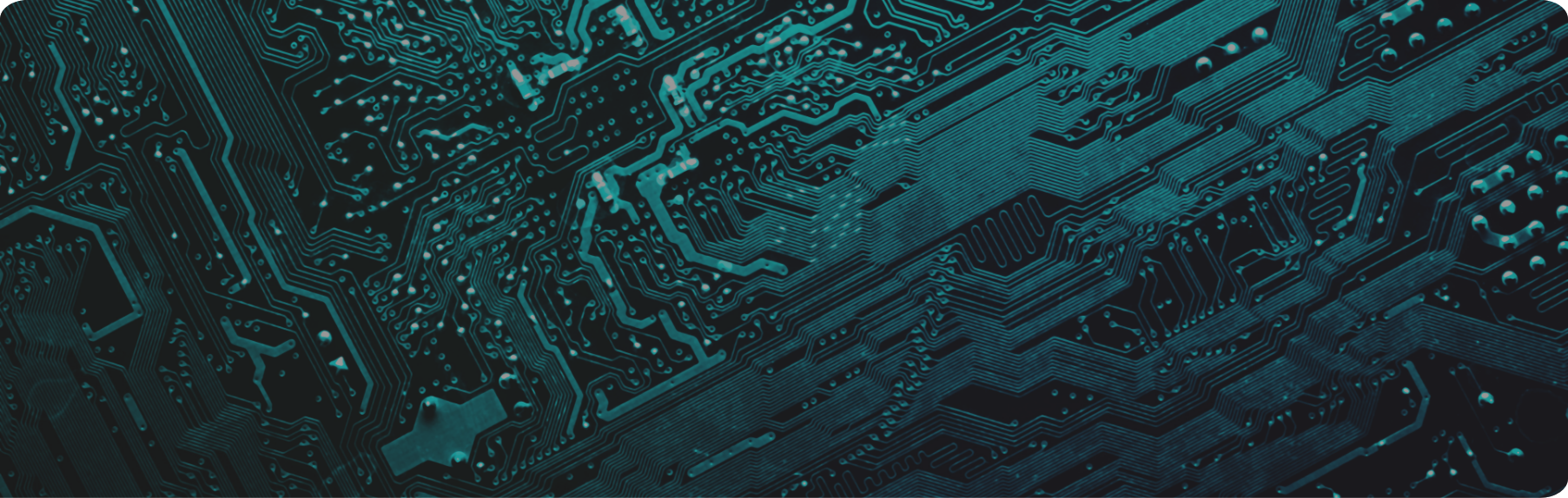 Close-up of a dark circuit board with intricate, interwoven pathways glowing in shades of teal and green.