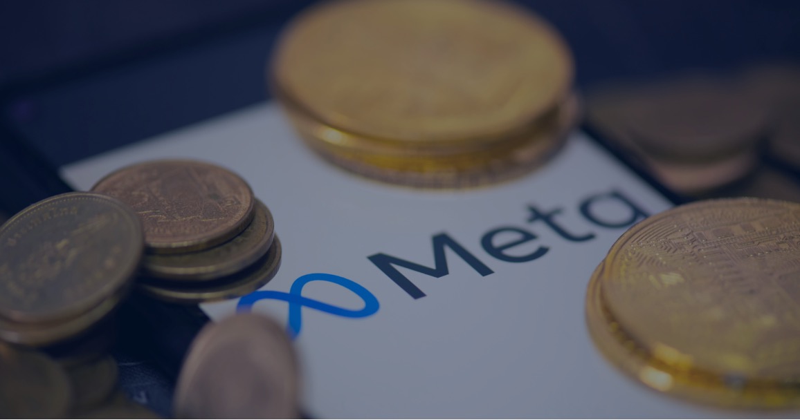 The Meta logo on paper, partially covered with coins