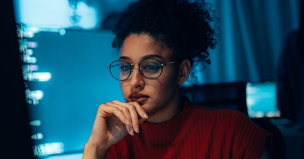 A person looking at a screen wearing glasses