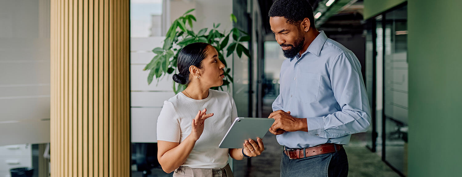 Business professionals discussing project on digital tablet
